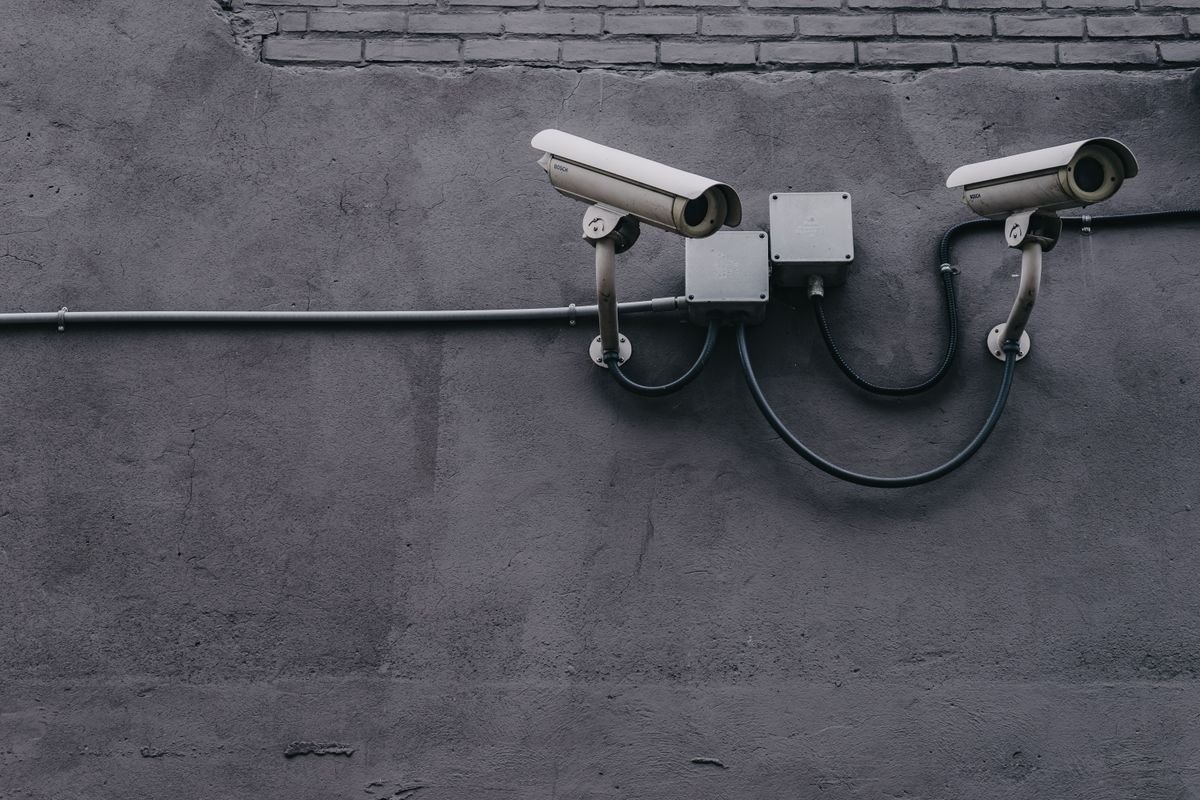 Two security cameras mounted on a wall